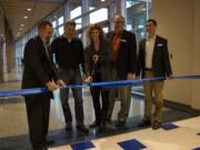 Ridgefield: Ridgefield School District board members Scott Gullickson, from left, Steve Radosevich, Becky Greenwald and Jeff Vigue cut a ribbon with Superintendent Nathan McCann at a Dec.