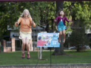 Jane Van Dyke, left, takes part in Give More 24! in a swinging marathon while Maxine Born-Bullock swings nearby in Vancouver on Thursday. The event is Clark County's annual 24-hour online giving competition, in which nonprofits encourage giving throughout the day with parties and promotions.