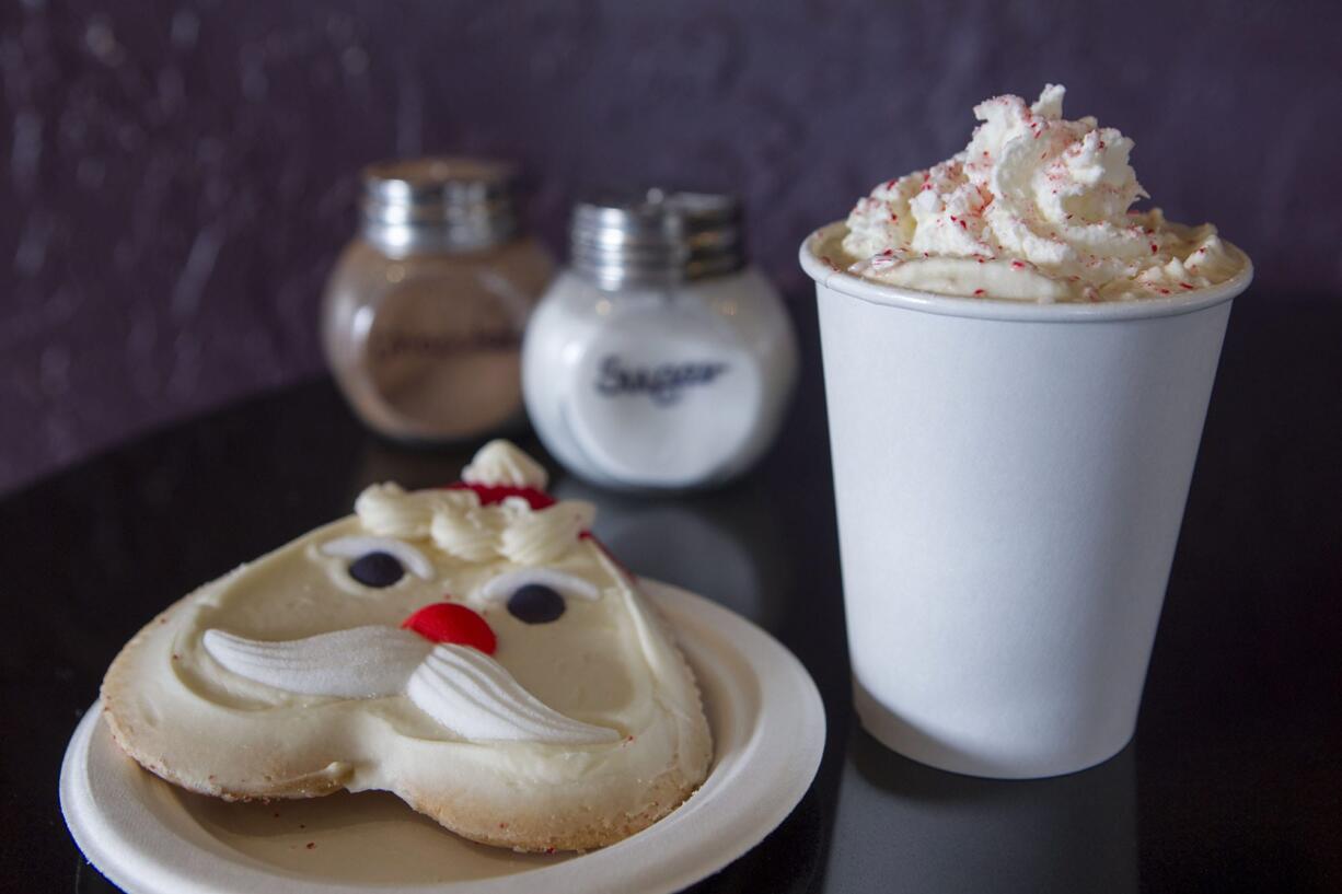 A candy cane mocha and a frosted Santa Claus cookie are served at the Squeeze and Grind in Camas.