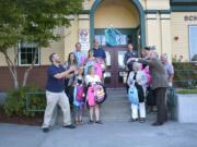 Camas: Members of the Camas-Washougal Rotary Club deliver backpacks filled with school supplies to Hathaway Elementary School.