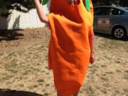 Salmon Creek: Ann Foster, organizer of the Salmon Creek Farmers' Markets, models an outfit inspired by the produce on sale at the market before it closed on Sept.