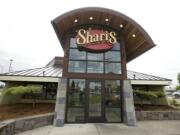 Work to install an arched timber portico over the main entrance to the hexagon-shaped Shari's Cafe &amp; Pies restaurant was part of a major construction facelift completed recently on the venue at 305 S.E.