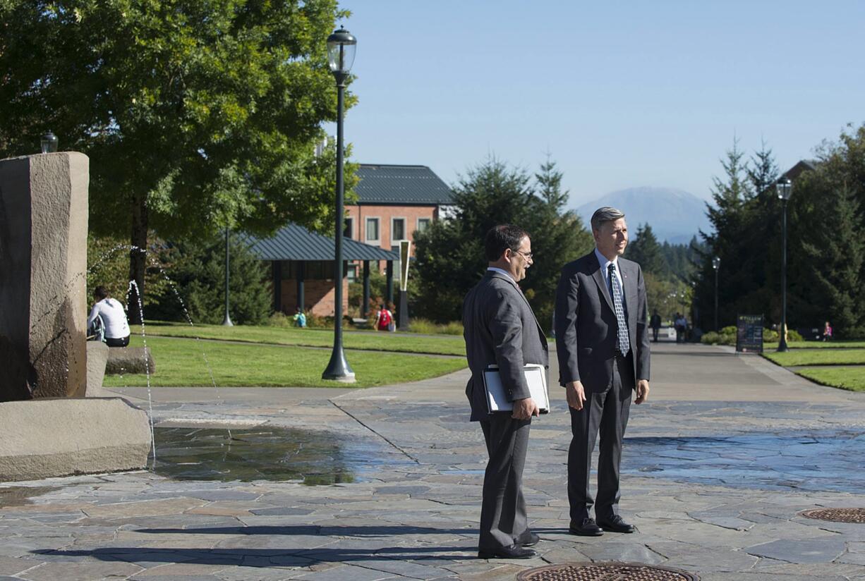 Dan Bernardo, left, who just took over as interim president of Washington State University, looks over views from the center of campus at Washington State University Vancouver with WSUV chancellor Mel Netzhammer III on Thursday morning, Sept. 10, 2015.