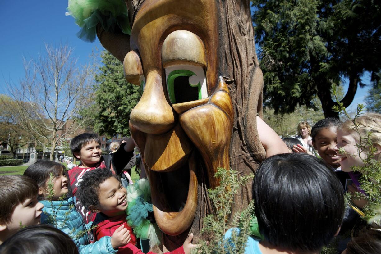 Children with the Marshall Community Center's spring break camp visit with Gary Oak Wednesday during the city of Vancouver's annual Arbor Day celebration in Esther Short Park.