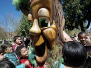 Children with the Marshall Community Center's spring break camp visit with Gary Oak Wednesday during the city of Vancouver's annual Arbor Day celebration in Esther Short Park.