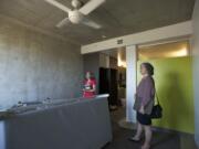 Bud Clark Commons property manager Rachel Duke, left, and public affairs director Shelley Marchesi give a tour of a vacant unit.