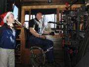 Joey Douglas, 9, left, the youngest docent with the Oregon Rail Heritage Center, with fireman Matt Baccitich, rides in the cab of the Spokane Portland