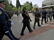 A multi-agency Honor Guard follows the posting of the colors during Thursday's Law Enforcement Memorial Ceremony in the courtyard of the Public Service Center in Vancouver.