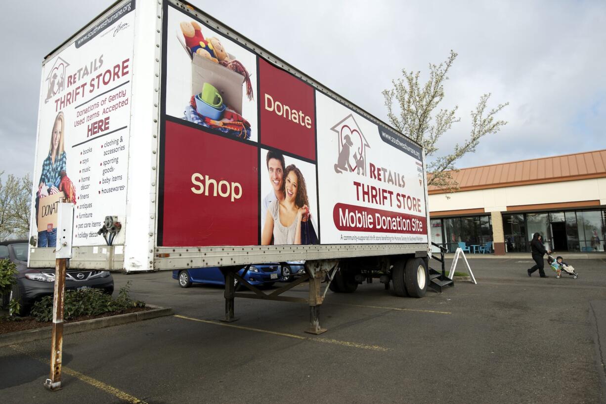 A collection trailer operates Thursday outside ReTails Thrift Store.