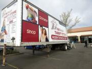 A collection trailer operates Thursday outside ReTails Thrift Store.