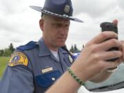 Washington State Patrol Trooper Will Finn takes a photo of a vehicle whose driver was not wearing a seat belt.