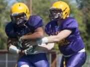 Running back Travon Santiago (L) and Quarter back Garrett McKee at a football practice at Columbia River High School in Vancouver Monday August 25, 2015.