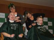 Camas: Teacher Angela Dasso, left, and sixth-grade student Jerrica Pachl lose their locks at a St. Baldrick's Foundation fundraising event on Jan.