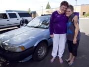 C-Tran bus driver Kerry Erving, left, gives a squeeze to Amanda Snapp, whom she discovered living in her car in the shared parking lot of Share and the Council for the Homeless.