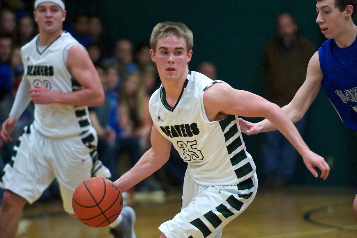 Woodland's Troy Flanagan moves the ball up the court against La Center in the second half at WHS on Friday January 24, 2014.