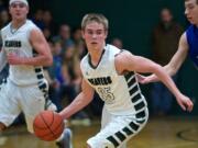 Woodland's Troy Flanagan moves the ball up the court against La Center in the second half at WHS on Friday January 24, 2014.