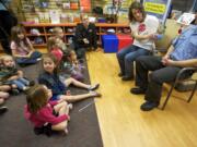 Becca Keen Cunningham of Vancouver, with her husband Jason Keen Cunningham, reads her book, &quot;If Kids Could Float: A Window Fall Prevention Story,&quot; to a group of children Wednesday at Randall Children's Hospital's Safety Center in Portland.