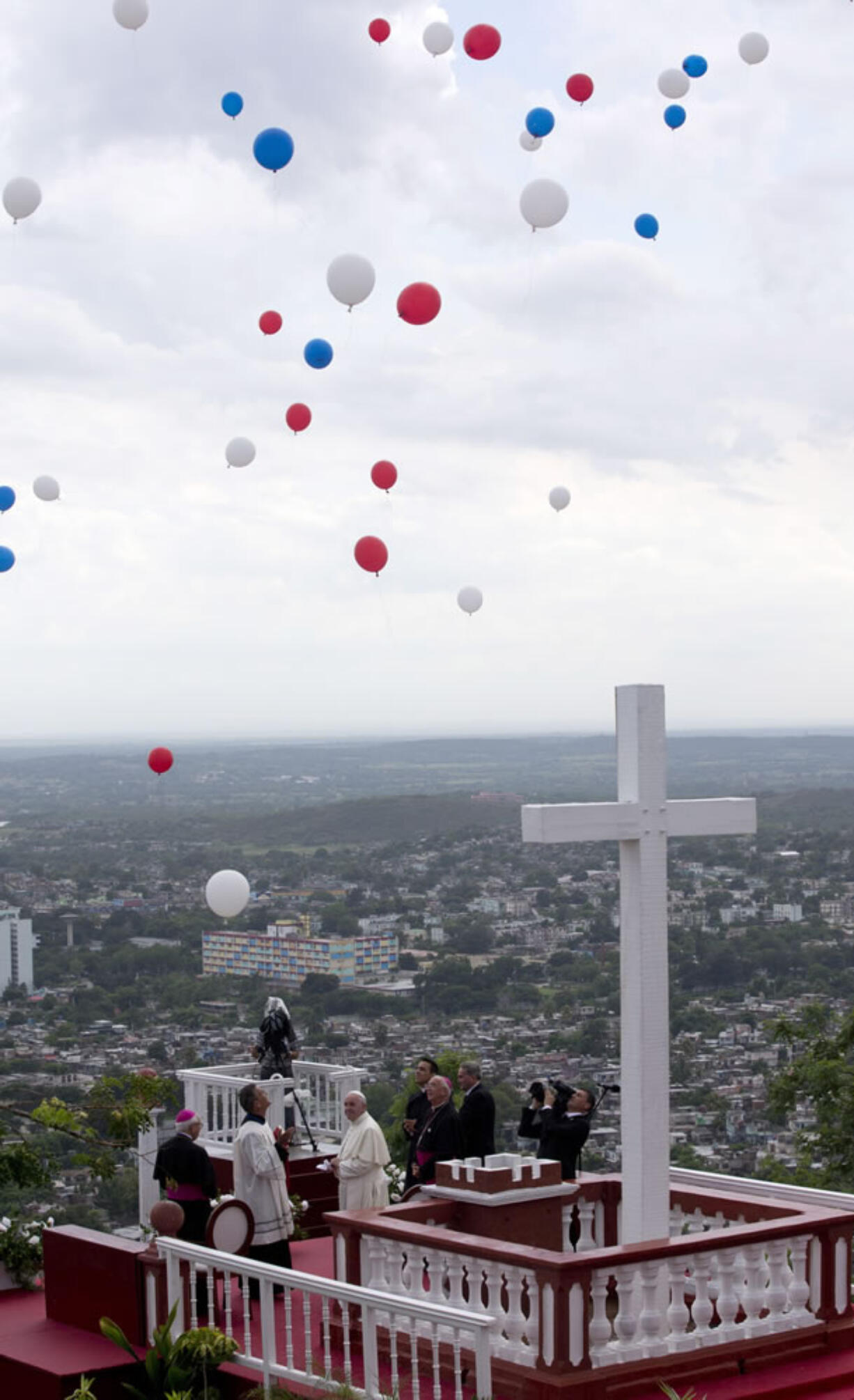 Balloons are released into the sky after a blessing by Pope Francis, from the pilgrimage site Hill of the Cross, over looking Holguin, Cuba, Monday, Sept. 21, 2015. Francis traveled to Cuba's fourth-largest city, Holguin, to celebrate a Mass at the Plaza of the Revolution, and visit the pilgrimage site, before heading to Santiago de Cuba.