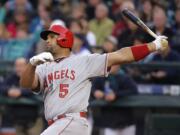 Los Angeles Angels' Albert Pujols watches his two-run home run in the first inning of a baseball game against the Seattle Mariners, Wednesday, April 8, 2015, in Seattle. (AP Photo/Ted S.