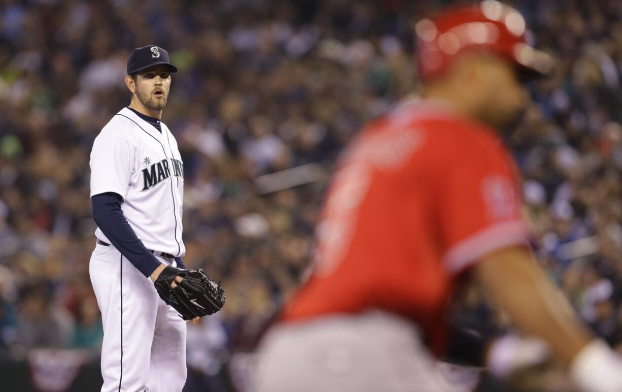 Seattle Mariners starting pitcher James Paxton, left, watches as Los Angeles Angels' Albert Pujols, right, rounds the bases after Pujols hit a two-run home run during in the first inning Tuesday.