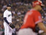 Seattle Mariners starting pitcher James Paxton, left, watches as Los Angeles Angels' Albert Pujols, right, rounds the bases after Pujols hit a two-run home run during in the first inning Tuesday.