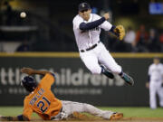 Seattle Mariners shortstop Brad Miller, right, leaps out of the way after forcing out Houston Astros' Dexter Fowler at second base in the fourth inning of a baseball game Sunday, May 25, 2014, in Seattle. Miller completed the play to first for the double play.