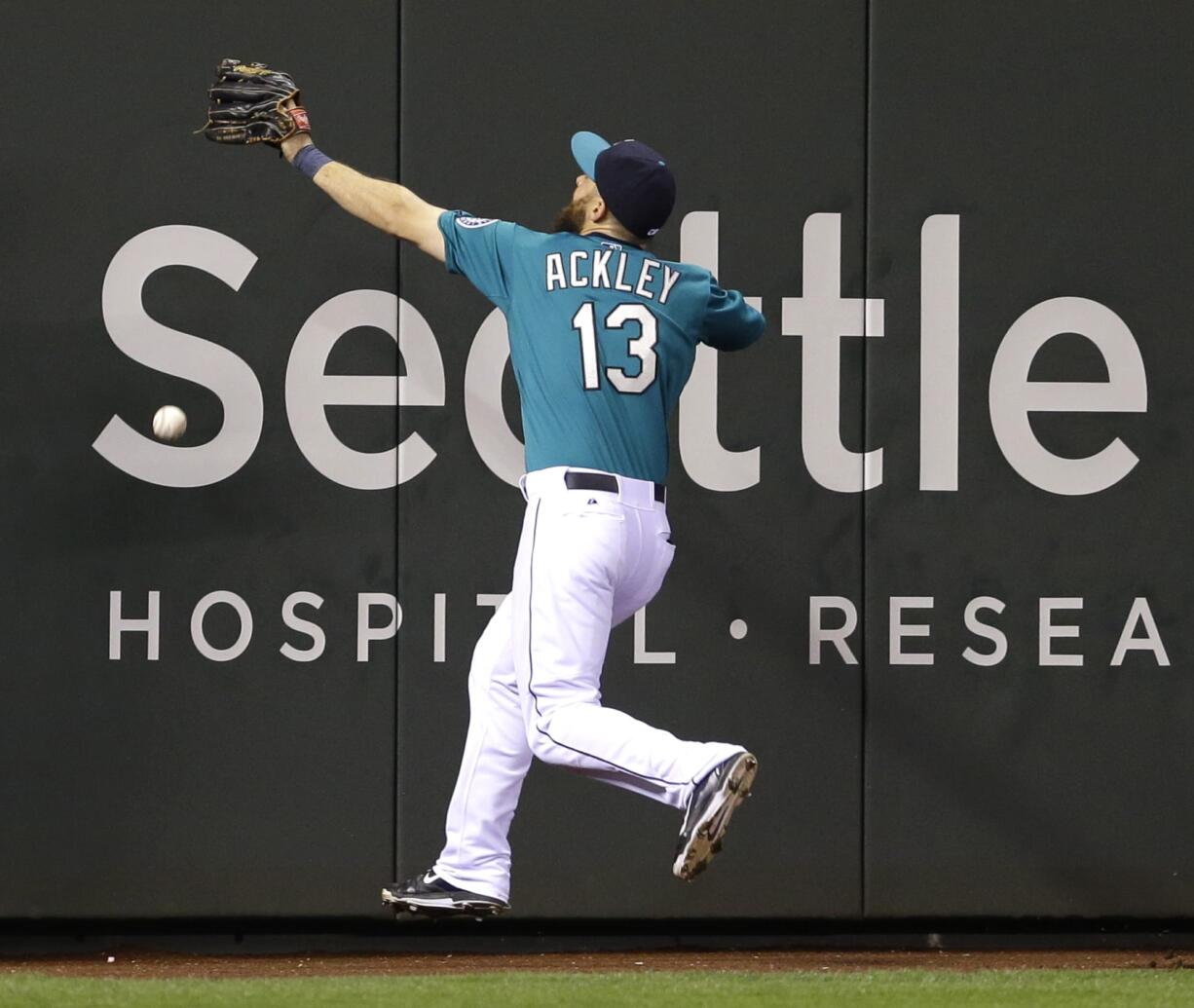 Seattle Mariners left fielder Dustin Ackley can't catch an RBI double hit by Houston's Matt Dominguez.