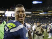 Seattle Seahawks quarterback Russell Wilson (3) smiles after the Seahawks' 34-6 win over the Chicago Bears in a preseason NFL football game Friday in Seattle.