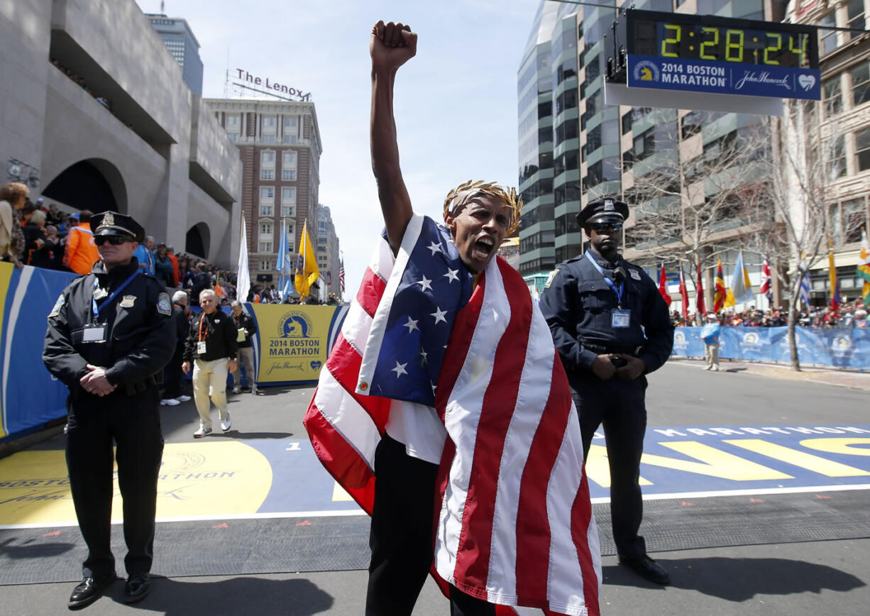 Meb Keflezighi, of San Diego, Calif., celebrates his victory in the 118th Boston Marathon, Monday, April 21, 2014, in Boston.(AP Photo/Elise Amendola)