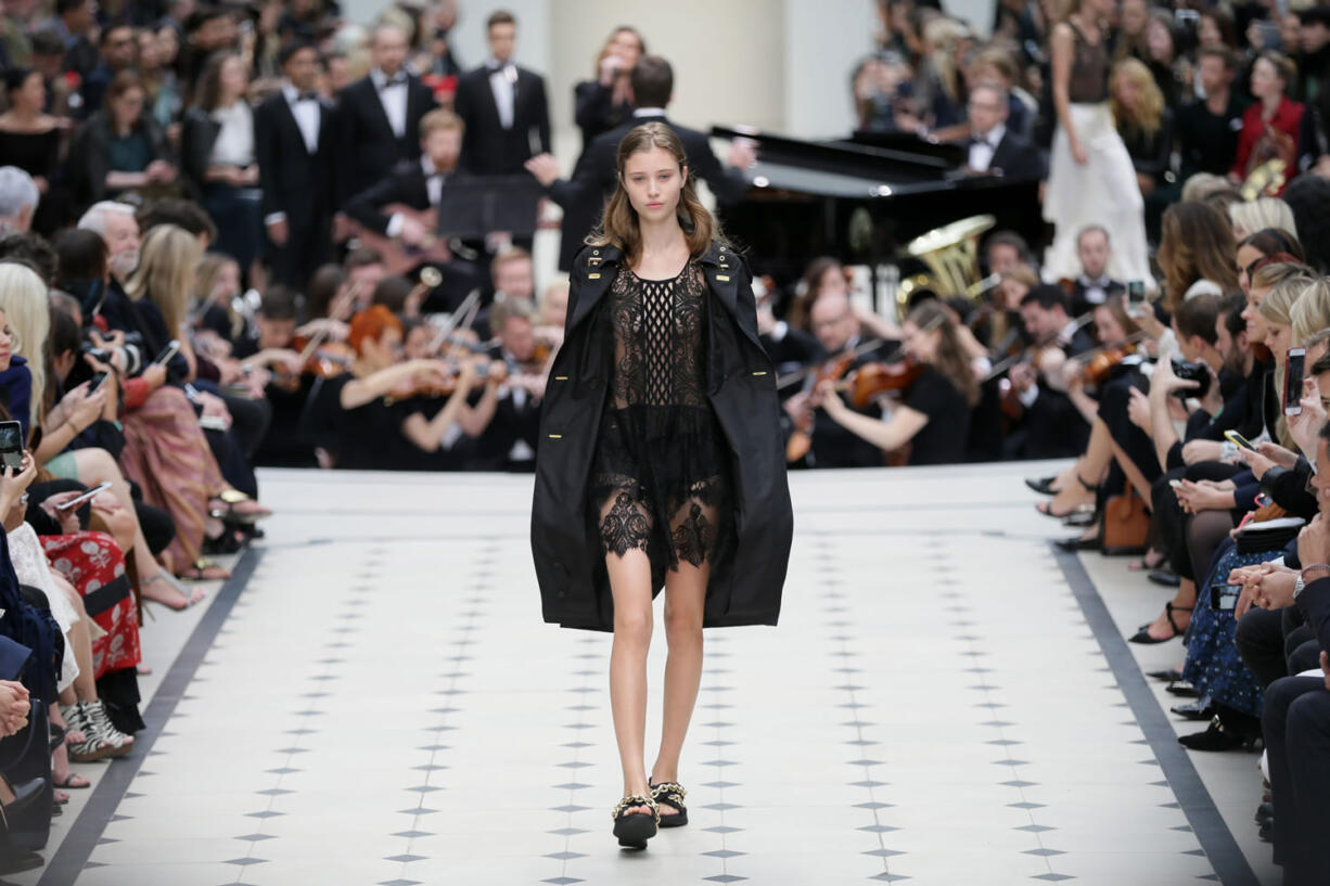 A model wears an outfit during the Spring/Summer 2016 Burberry show for London Fashion Week at Kensington Gardens west lawn, in London, on Monday.