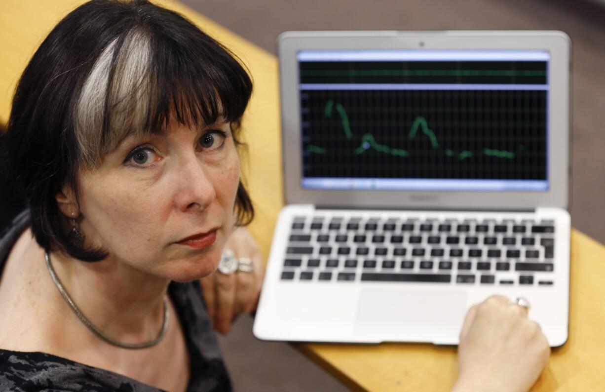 Jane Setter, professor of phonetics at University of Reading, poses for a photograph in London on Wednesday, as she sets up her voice analyst program to analyses the voice the man who speaks on a video before seemingly killing journalist James Foley. Setter said the man was likely educated in the U.K.