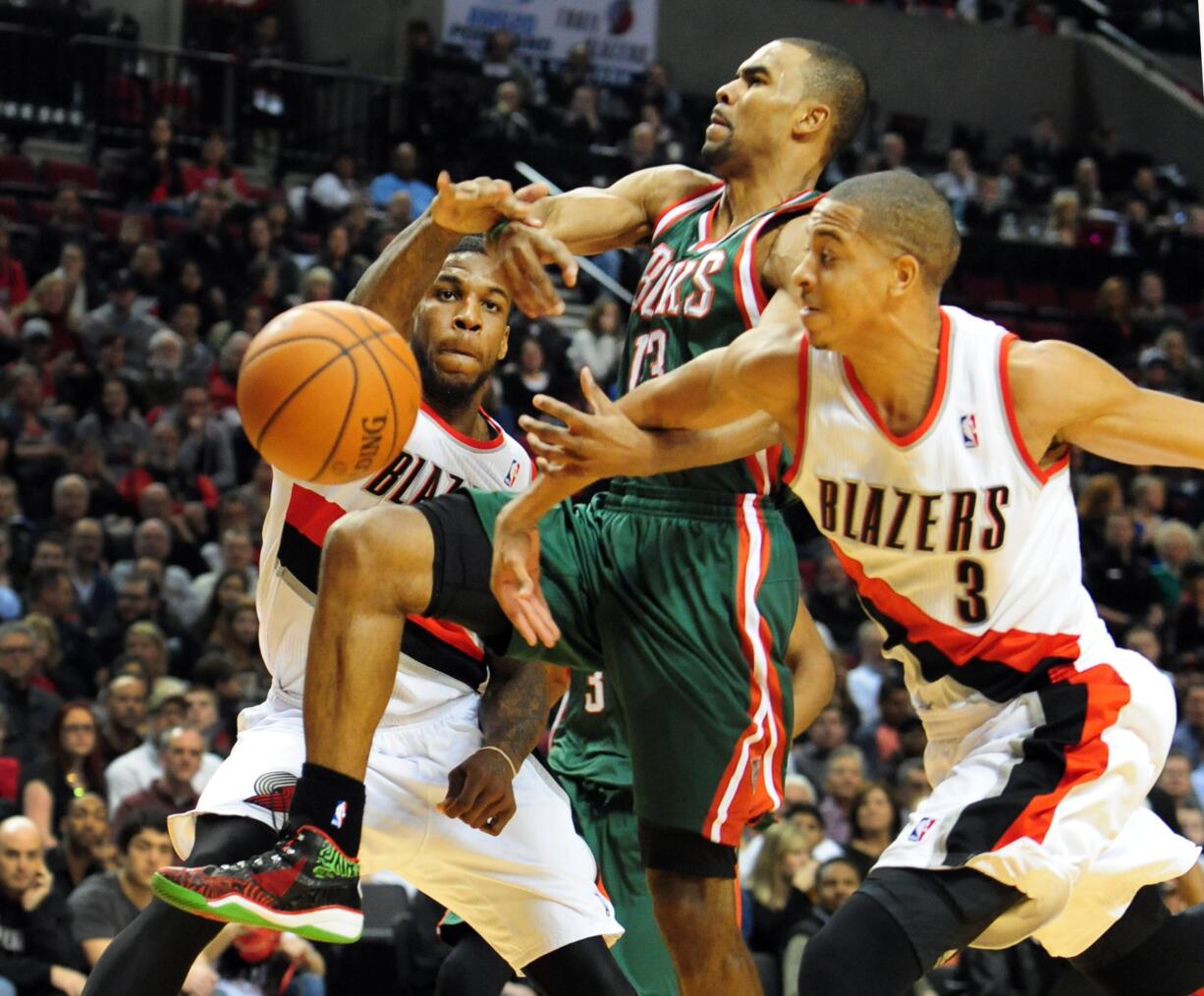 Milwaukee Bucks guard Ramon Sessions (13) has the ball knocked away by Portland Trail Blazers forward Thomas Robinson (41) and guard C.J.