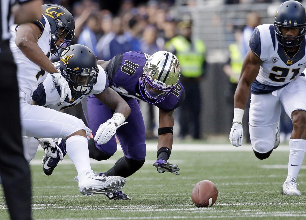 Washington wide receiver Isaiah Renfro (18) watches his fumble as California defenders Hardy Nickerson, left, Darius Allensworth and Stefan McClure (21) surround the ball during the first half Saturday, Sept. 26, 2015, in Seattle. Allensworth recovered for Cal.