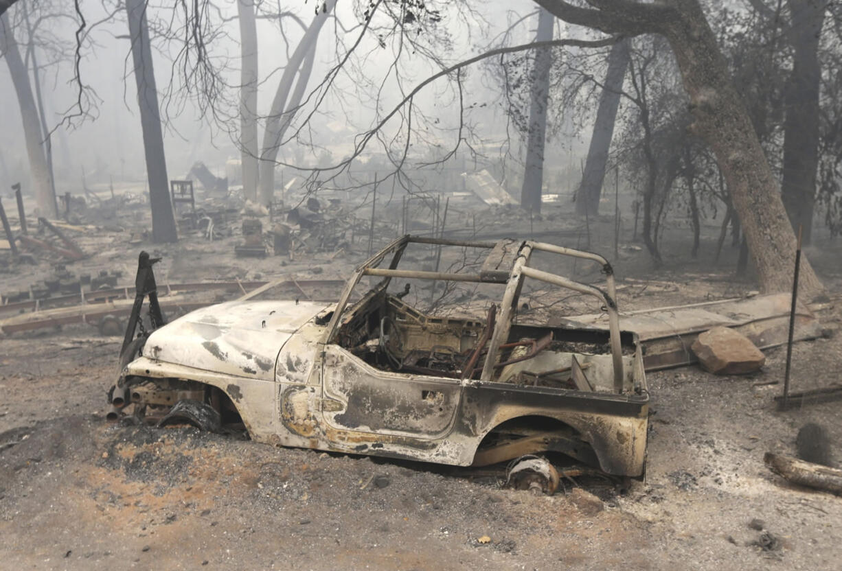 A vehicle destroyed by the Butte Fire sits Saturday on tireless rims at a home in Mountain Ranch, Calif. Firefighters gained some ground Saturday against the explosive wildfire that incinerated buildings and chased hundreds of people from mountain communities in drought-stricken Northern California.