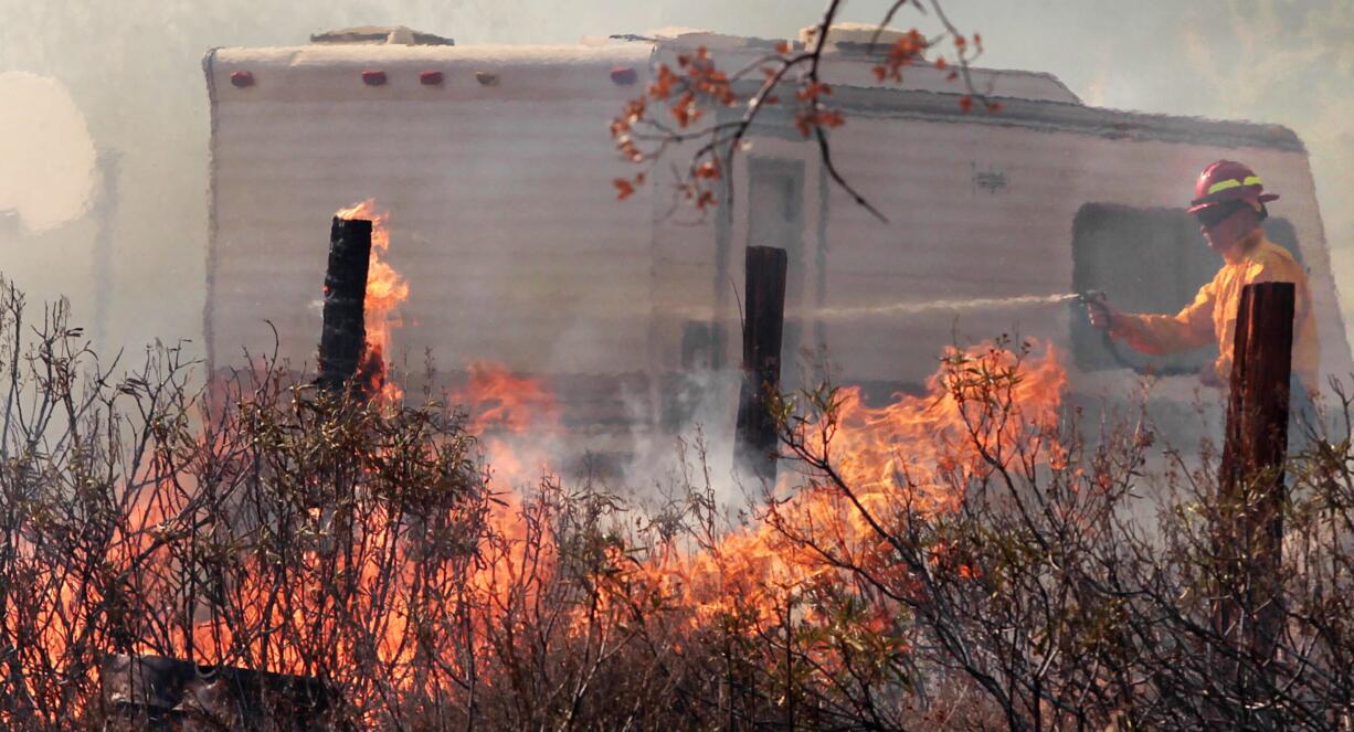 A Kern County Firefighter works  to put out the Way Fire on in the hills above Wofford Heights, Calif., on Monday. The fire in Wofford Heights near Lake Isabella has grown to about slightly more than 1 square mile, or 800 acres, the U.S.