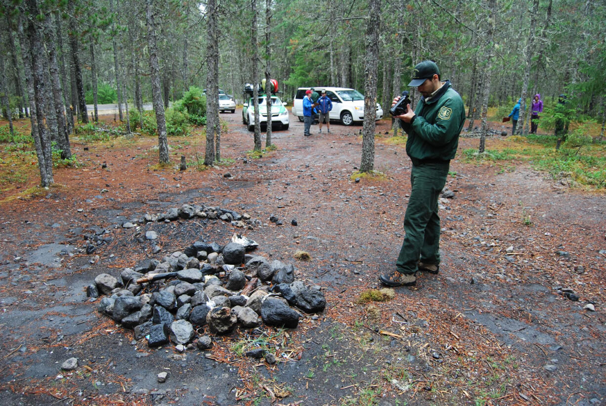 Zach Teel of the Forest Service documents a campsite a few yards from the upper Kalama River.