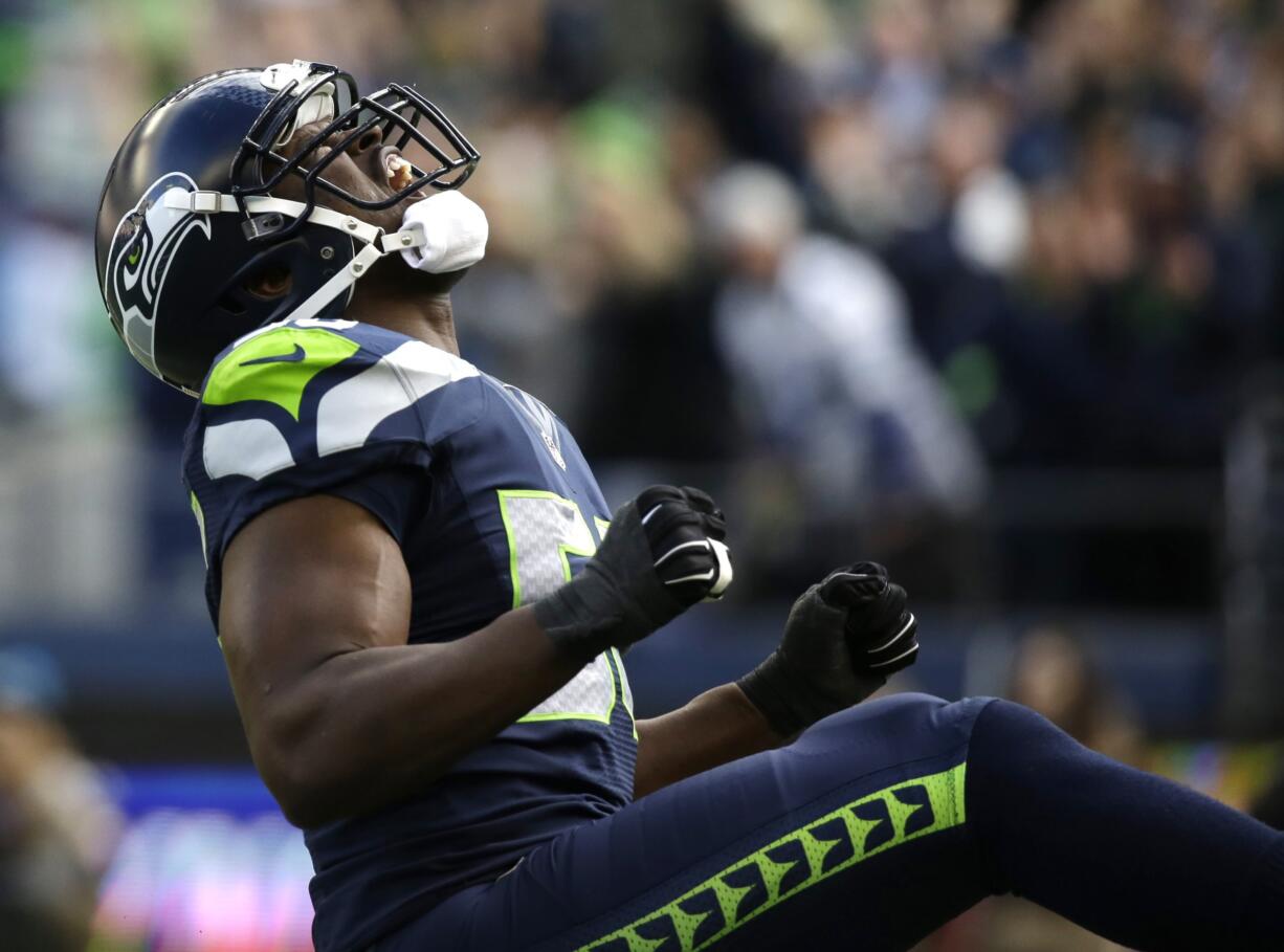 Seattle Seahawks defensive end Cliff Avril reacts after he sacked Arizona Cardinals quarterback Drew Stanton in the first half of an NFL football game, Sunday, Nov. 23, 2014, in Seattle.