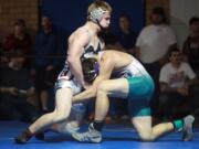 Alex Berfanger of Union High School, left, wrestles  at the Clark County Wrestling Championships in January.