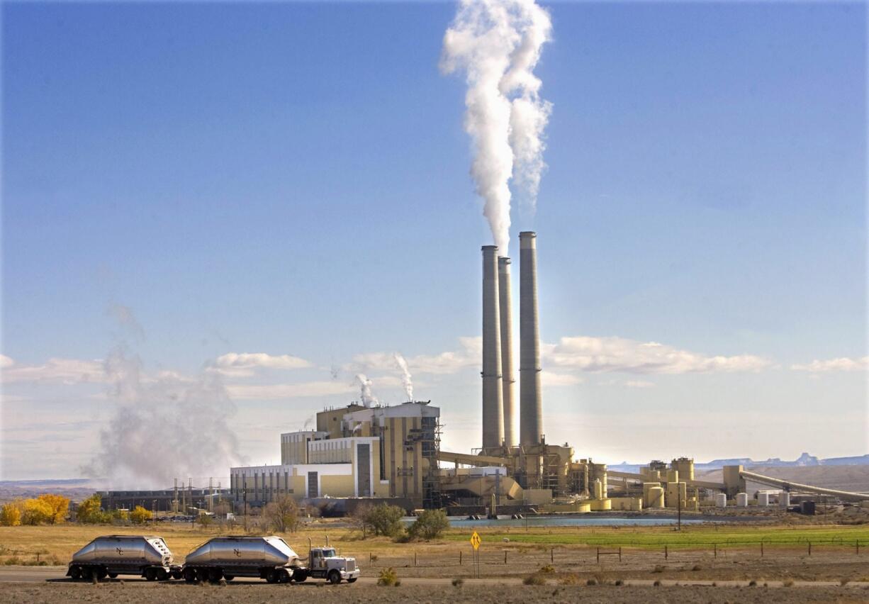 Coal trucks leave the coal-fired Hunter Power Plant just south of Castle Dale, Utah, in 2009 after making a delivery.