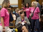 As supporters of Planned Parenthood looks for seats, Melissa Ohden, center, pro-life supporter from Gladstone, Mo., waits to testify before the House Judiciary Committee hearing at the Capitol in Washington examining the abortion practices of Planned Parenthood on Wednesday.