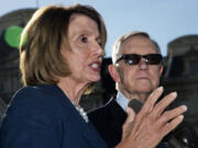 House Minority Leader Nancy Pelosi of California, left, accompanied by Senate Minority Leader Harry Reid of Nevada, speaks to reporters outside the West Wing of the White House in Washington on Thursday after a meeting with President Barack Obama.