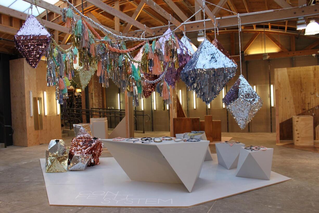 A ConfettiSystem installation features quartz and crystal pinatas and twist rope garlands. ConfettiSystem transforms simple materials such as tissue paper, cardboard, and silk into interactive objects that are filled with hand-cut confetti.