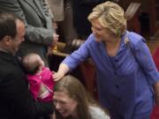 Democratic presidential candidate Hillary Rodham Clinton, right, and her daughter, Chelsea, greet congregants after attending the Foundry United Methodist Church for their Bicentennial Homecoming Celebration in Washington on Sunday.