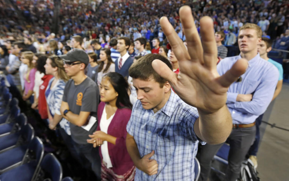 Liberty University students pray before a speech by Democratic presidential candidate Sen. Bernie Sanders, I-Vt., at Liberty University  in Lynchburg, Va., on Monday.