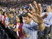 Liberty University students pray before a speech by Democratic presidential candidate Sen. Bernie Sanders, I-Vt., at Liberty University  in Lynchburg, Va., on Monday.