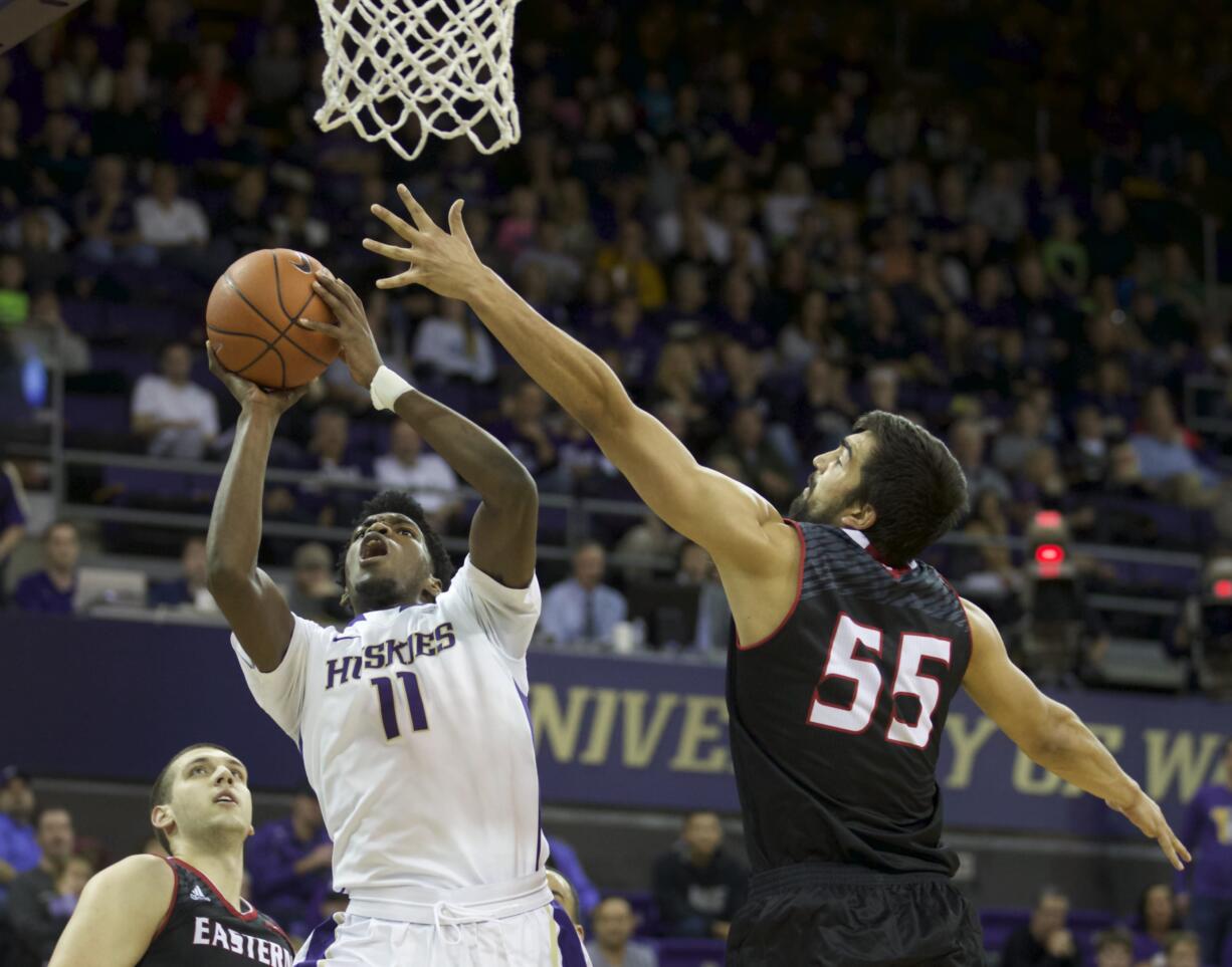 Washington's Mike Anderson (11) shoots the ball over Eastern Washington's Venky Jois during in the first half  Sunday, Dec. 14, 2014 in Seattle.