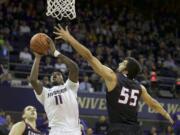 Washington's Mike Anderson (11) shoots the ball over Eastern Washington's Venky Jois during in the first half  Sunday, Dec. 14, 2014 in Seattle.