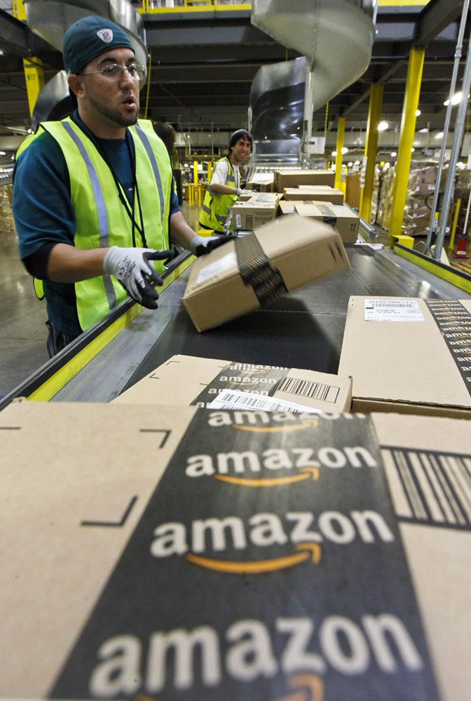 A worker gets packages ready for shipping at the Amazon.com fulfillment center in Phoenix.