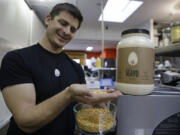 Hampton Creek Foods CEO Josh Tetrick holds a species of yellow pea used to make Just Mayo, a plant-based mayonnaise, in San Francisco. The American Egg Board, which is responsible for the "Incredible, Edible Egg" slogan, waged a campaign to counter the rising popularity of Hampton Creek's eggless Just Mayo spread, and even tried to stop it from being sold at Whole Foods, according to documents provided to The Associated Press.