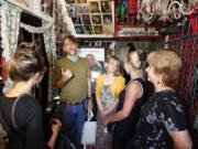 Vernon Chadwick of Oxford, second from left, gives visitors a tour of the front rooms of Graceland Too, the antebellum home of the late Paul MacLeod.